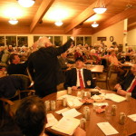 Ralph leads the crowd in singing "I've been working on the railroad"